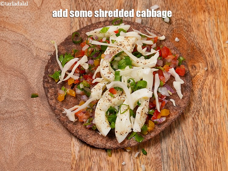 Step 27 – Add some <a href="https://www.tarladalal.com/glossary-shredded-cabbage-763i">shredded cabbage</a>.&nbsp;