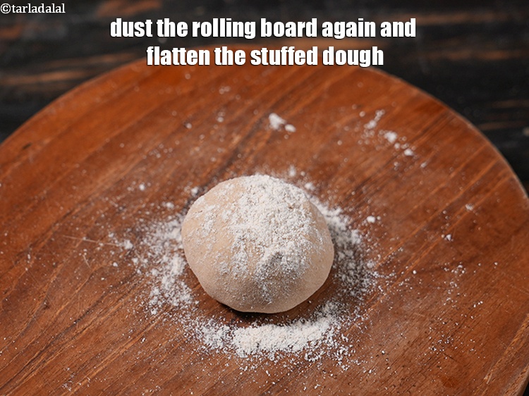 Step 29 – Dust the rolling board again and flatten the stuffed dough.