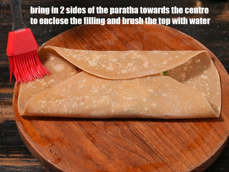 Step 45 – Brush water over the edges of the paratha that will help seal the paratha.
