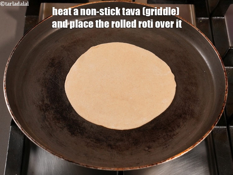 Step 28 – Heat a non-stick tava (griddle) and place the rolled roti over it.