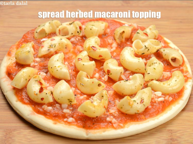 Step 28 – Spread &frac14; the of the herbed macaroni topping.