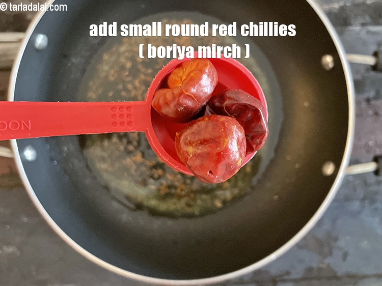 Step 26 – Add&nbsp;<meta charset="UTF-8" />4&nbsp;small&nbsp;<a href="glossary-round-red-chillies-boriya-chilli-boria-mirch-1096i">round red chillies (boriya mirch)</a>.