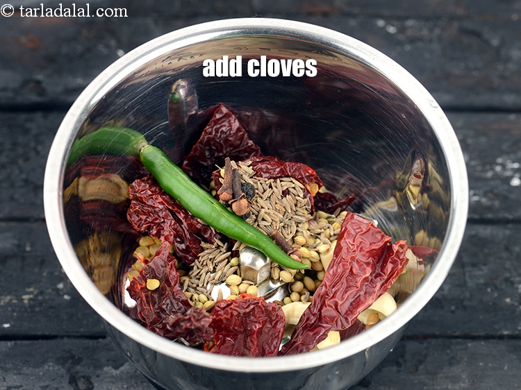 Step 27 – Add 4 <a href="https://www.tarladalal.com/glossary-cloves-laung-lavang-322i">cloves (laung / lavang)</a>.