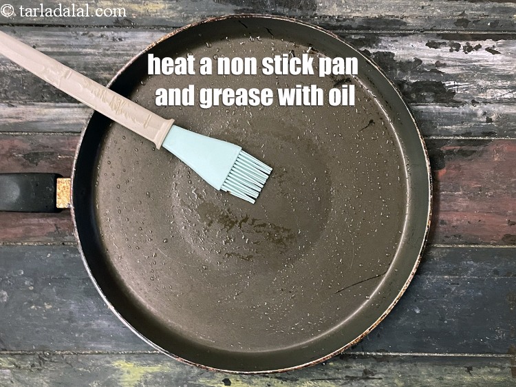 Step 27 – <meta charset="UTF-8" />Heat a non-stick tava (griddle) and grease it using &frac14; tsp of oil.