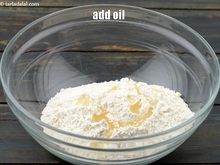 Step 27 – Add&nbsp;<a href="https://www.tarladalal.com/glossary-oil-671i">oil</a>&nbsp;for kneading.