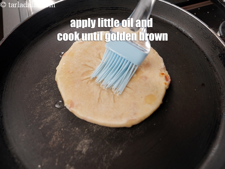 Step 26 – Apply a little oil and cook until golden brown spots appear on both the sides.