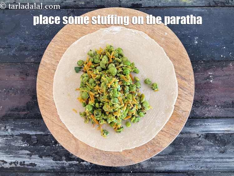 Step 28 – Place a dough circle on a flat, dry surface and spread a portion of the …