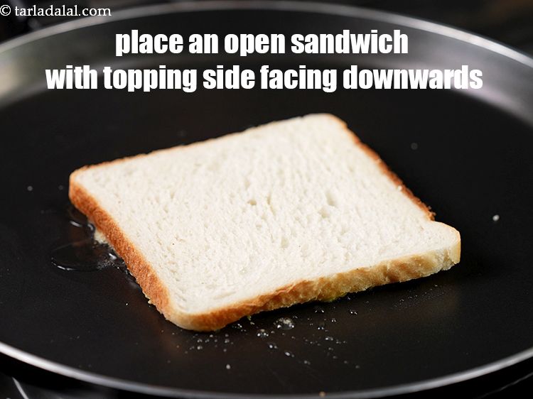 Step 26 – Place an open sandwich on the greased tava (griddle) with the topping side facing downwards.