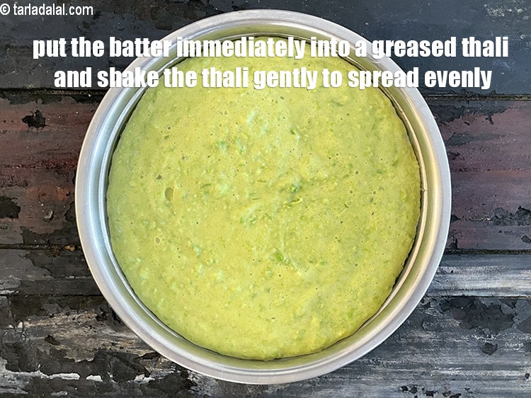 Step 26 – Pour the batter immediately into a greased thali and shake the thali to spread it …