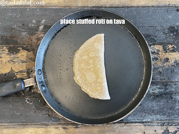 Step 35 – After stuffing it, the roti has to be cooked on a medium flame.&nbsp;