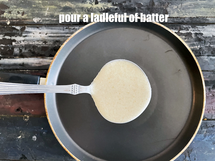 Step 30 – Pour a ladleful of the batter on the tava (griddle).