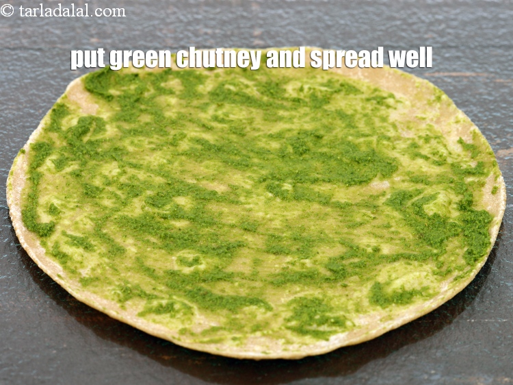 Step 27 – Put 1 tsp of <a href="https://www.tarladalal.com/green-chutney-22266r">green chutney</a> and spread it well.