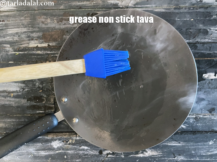Step 23 – <meta charset="UTF-8" /> Heat a non-stick tava (griddle) and grease with oil.