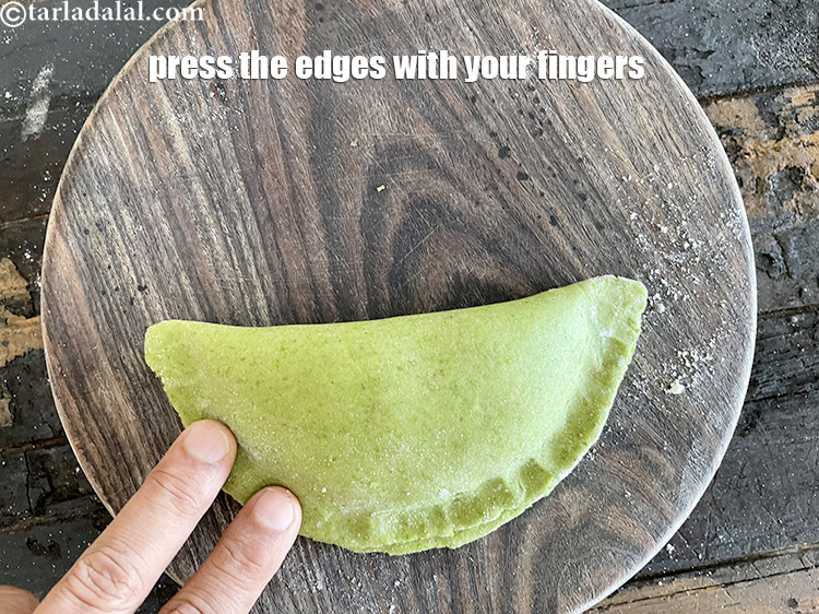 Step 46 – Press the edges with your fingers to seal the paratha.