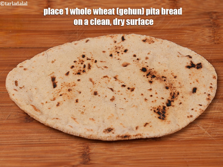 Step 29 – Place 1 whole&nbsp;<a href="https://www.tarladalal.com/pita-bread-lebanese-whole-wheat-pita-bread-22571r" target="_blank">wheat (gehun)&nbsp;pita bread</a>&nbsp;on a clean, dry surface