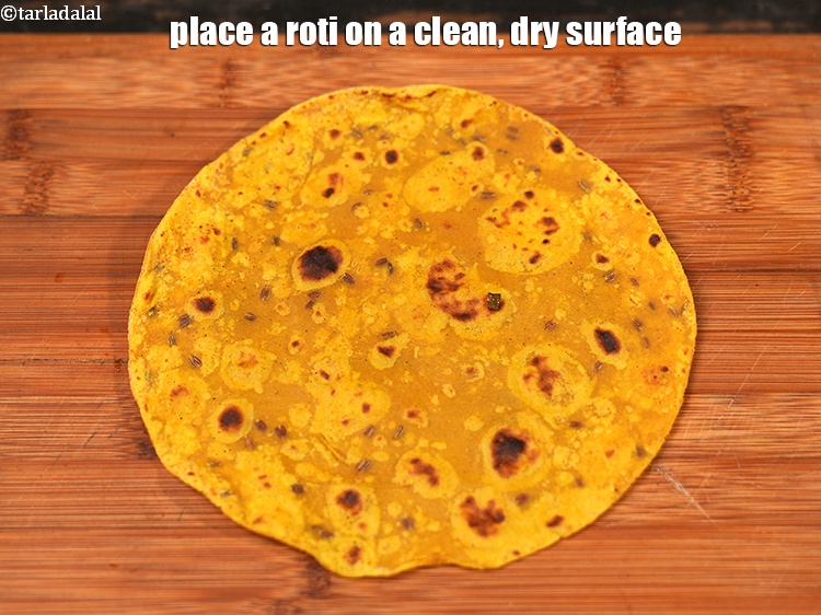 Step 27 – Place a roti on a clean, dry surface.