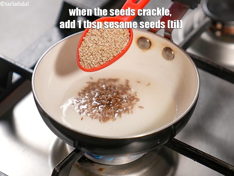 Step 33 – When the seeds crackle, add 1 tbsp&nbsp;<a href="https://www.tarladalal.com/glossary-sesame-seeds-til-gingelly-seeds-612i">sesame seeds (til)</a>.