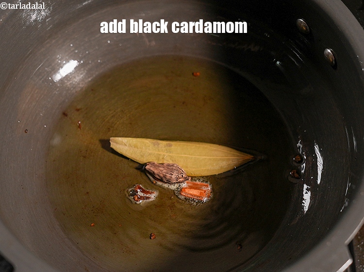Step 27 – Add 1 <a href="https://www.tarladalal.com/glossary-black-cardamom-badi-elaichi-moti-elaichi-263i">black cardamom (badi elaichi)</a>.