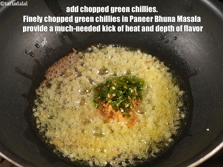 Step 27 – Add 2 tsp <a href="https://www.tarladalal.com/glossary-chopped-green-chilli-820i">chopped green chillies</a>. Finely chopped green chillies in Paneer Bhuna Masala …