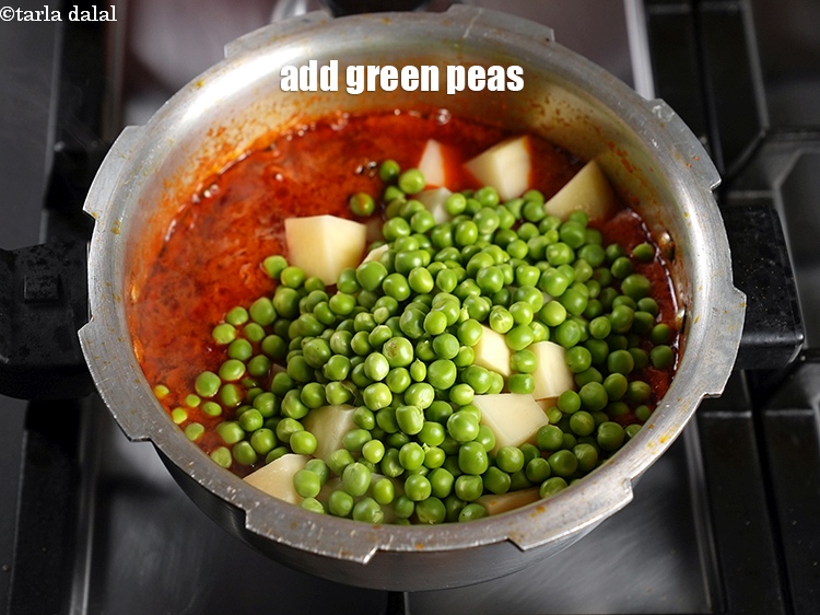 Step 27 – Add 1 cup <a href="https://www.tarladalal.com/glossary-green-peas-matar-hare-matar-vatana-180i">green peas</a>.