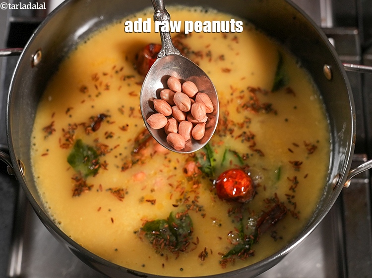Step 27 – Add 1 tbsp <a href="https://www.tarladalal.com/glossary-raw-peanuts-kachi-mungfali-kachi-moongfali-847i">raw peanuts</a>.