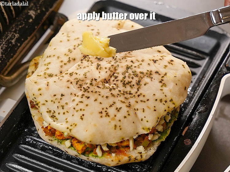 Step 27 – Apply &frac12; tsp <a href="https://www.tarladalal.com/glossary-butter-makhan-233i">butter</a> over it.