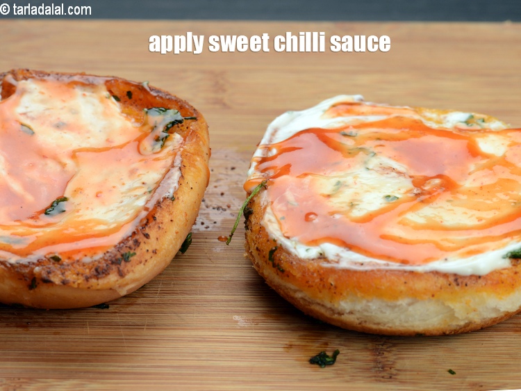 Step 27 – Apply 1 tsp <a href="https://www.tarladalal.com/glossary-sweet-chilli-sauce-1306i">sweet chilli sauce</a> on each halve.