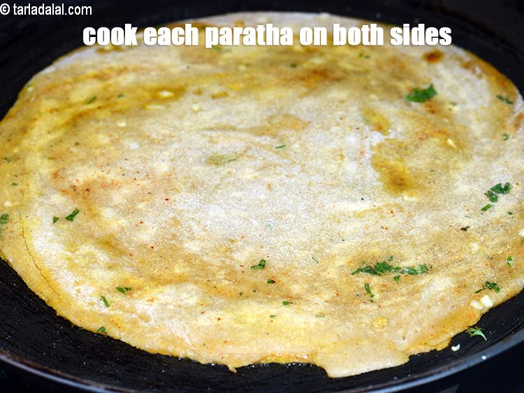 Step 27 – Cook each paratha on both the sides, while pressing.