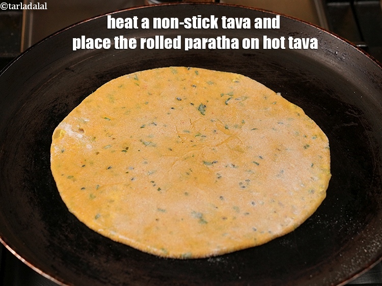 Step 27 – Heat a non-stick tava (griddle) and place the rolled paratha on hot tava.