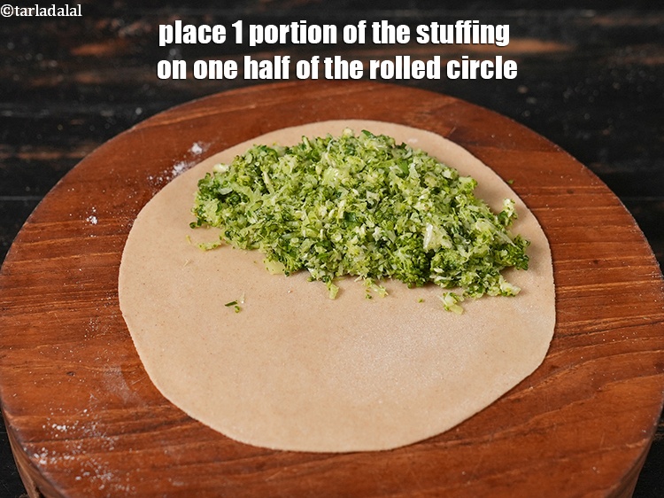 Step 26 – Place 1 portion of the stuffing on one half of the rolled circle.