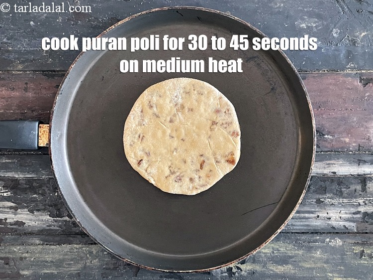 Step 34 – <meta charset="UTF-8" />Cook puran poli for 30 to 45 seconds on a medium flame.&nbsp;&nbsp;&nbsp;