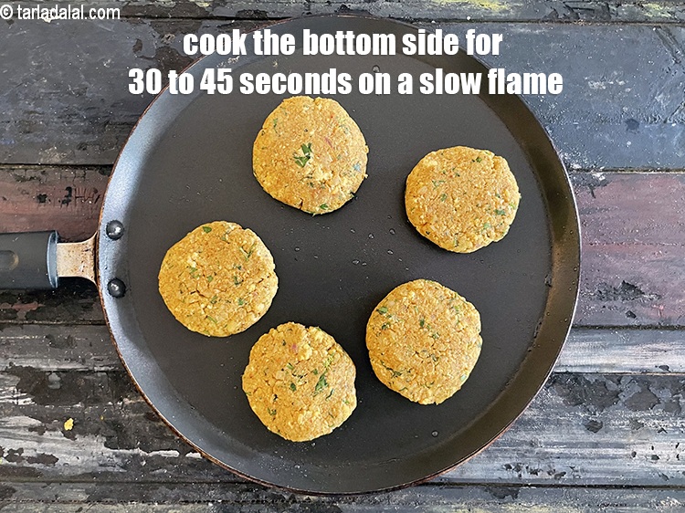 Step 35 – Cook the bottom side of the&nbsp;tikkis on a slow flame&nbsp;for 30 to 45 seconds.