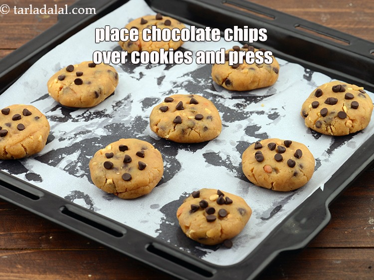 Step 26 – Place few chocolate chips over each cookie and press it gently.&nbsp;