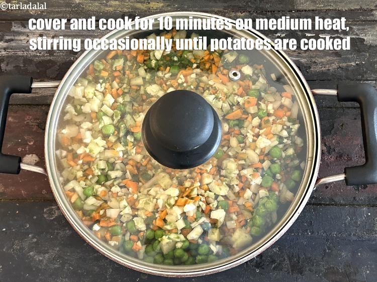 Step 27 – <strong>Cover and cook</strong> on a medium flame for <strong>10&nbsp;minutes </strong>while stirring occasionally till potatoes are …