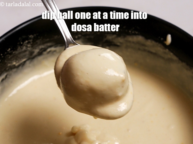 Step 28 – Dip the aloo masala ball one at a time into the dosa batter.