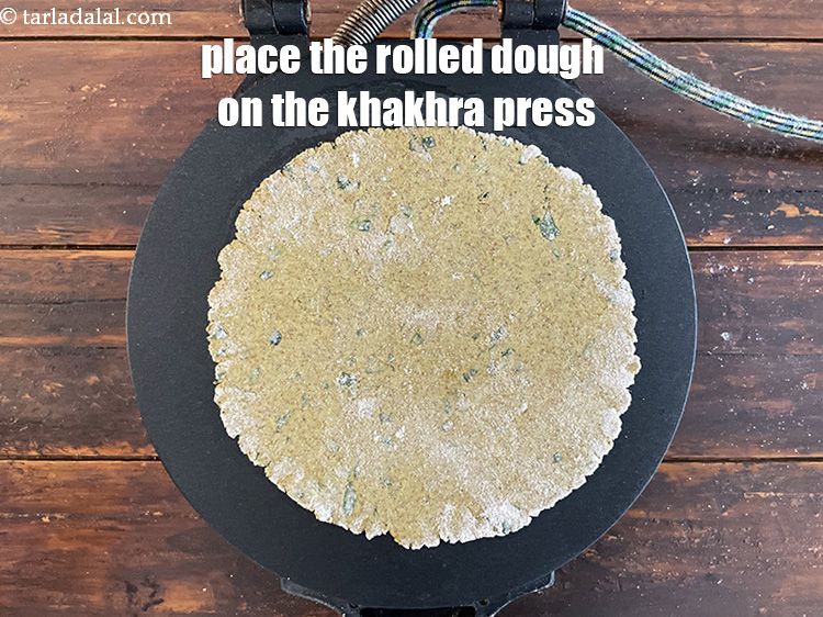 Step 40 – <meta charset="UTF-8" /> Place the rolled khakhra in the&nbsp;khakhra press. Let it cook open for …