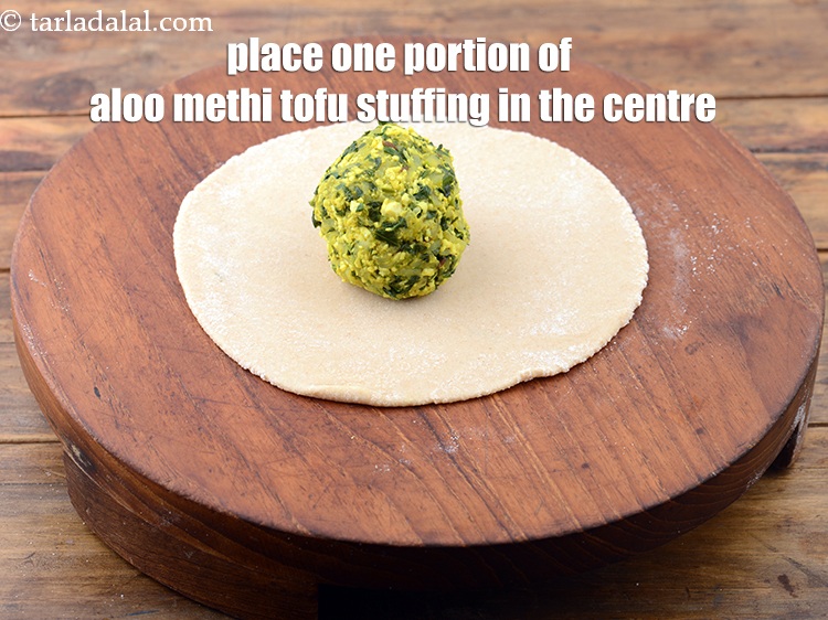 Step 28 – Place one portion of the aloo methi tofu stuffing in the centre of the circle.