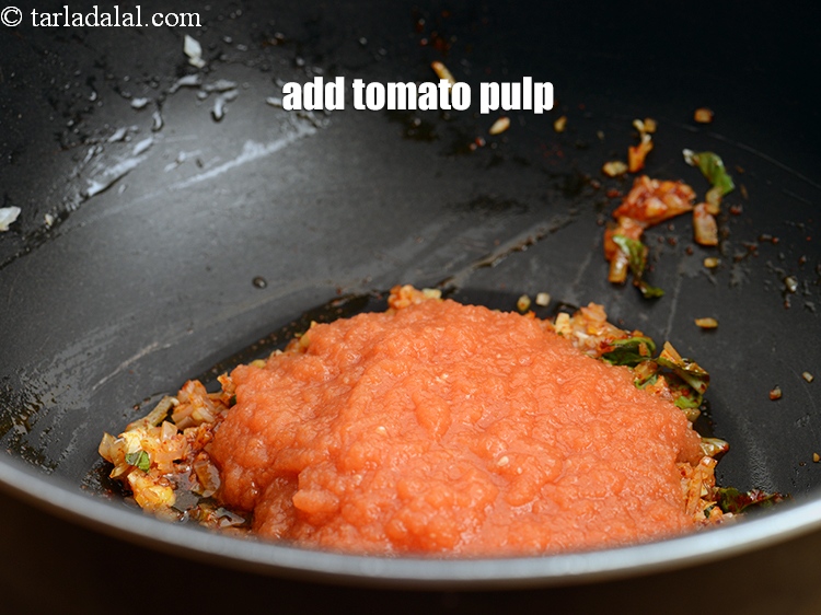 Step 29 – Add 1 cup <a href="https://www.tarladalal.com/glossary-tomato-pulp-tamatar-ka-pulp-1039i">tomato pulp</a>.