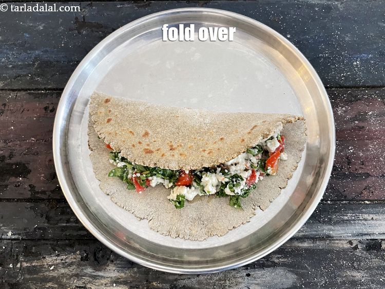 Step 30 – Fold over the roti over the stuffing. We are now going to cook the roti …