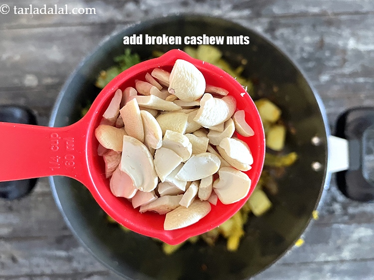 Step 26 – Add&nbsp;<meta charset="UTF-8" />1/4 cup&nbsp;broken&nbsp;<a href="glossary-cashew-nuts-kaju-840i">cashew nuts (kaju)</a>.