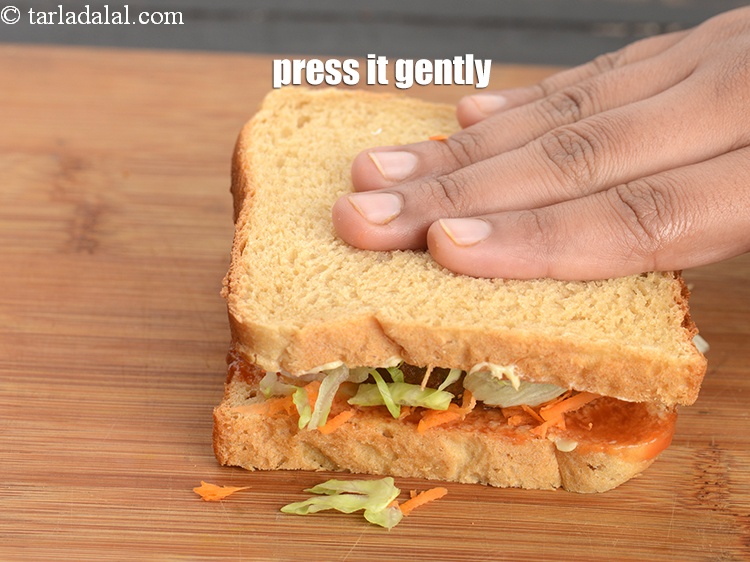Step 31 – Press the tikki gently after placing it on the bread slices.