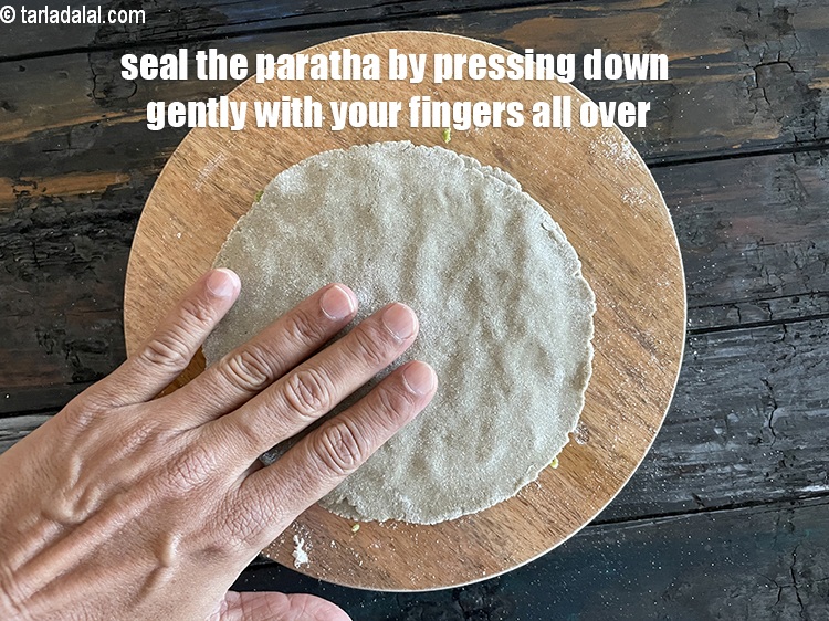 Step 28 – Seal the paratha by pressing down with your fingers over the centre and edges of …