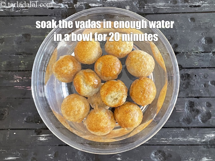 Step 27 – Soak the vadas in enough water in a deep bowl for 20 minutes.
