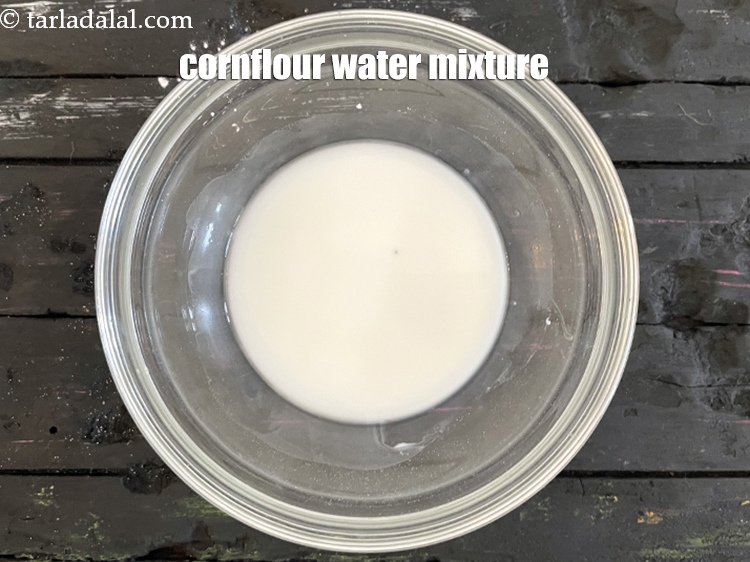 Step 32 – Keep aside cornflour water mixture to be used in the <strong>corn tomato and spinach soup.</strong>