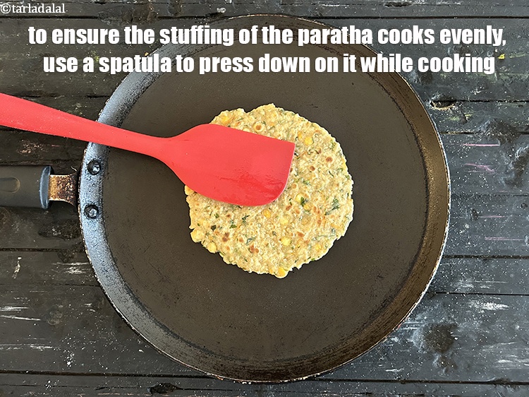 Step 28 – <meta charset="UTF-8" />To ensure that the stuffing in the paratha cooks evenly, use a spatula …