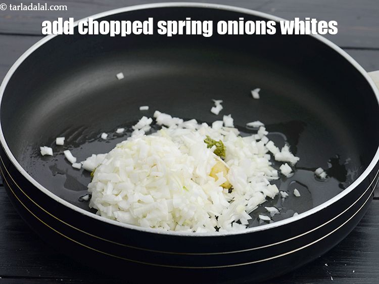 Step 28 – Add 1/2 cup&nbsp;finely&nbsp;<a href="https://www.tarladalal.com/glossary-chopped-spring-onion-whites-815i">chopped spring onions whites</a>.