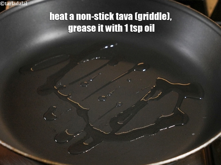 Step 34 – Heat a non-stick tava (griddle), grease it with 1 tsp <a href="https://www.tarladalal.com/glossary-oil-671i">oil</a>.