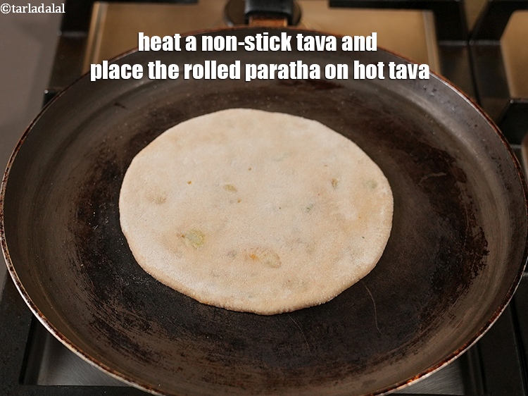 Step 27 – Heat a non-stick tava (griddle), and place the rolled paratha on hot tava.