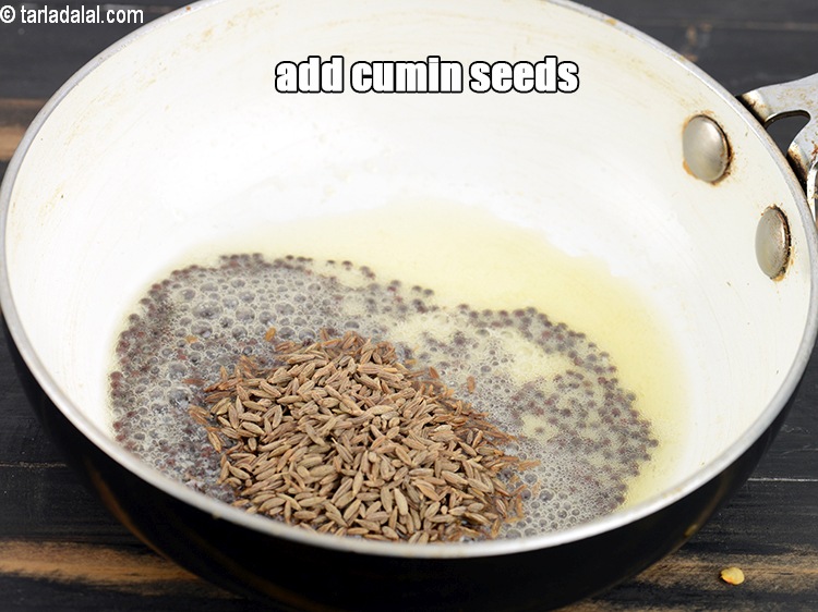 Step 29 – When the seeds crackle, add 1 tsp cumin seeds.