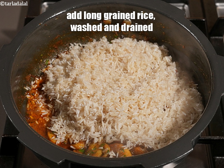 Step 28 – Add 1&frac14; cups <a href="https://www.tarladalal.com/glossary-long-grain-rice-basmati-chawal-basmati-rice-535i">long grained rice (basmati)</a>&nbsp;, washed and drained.
